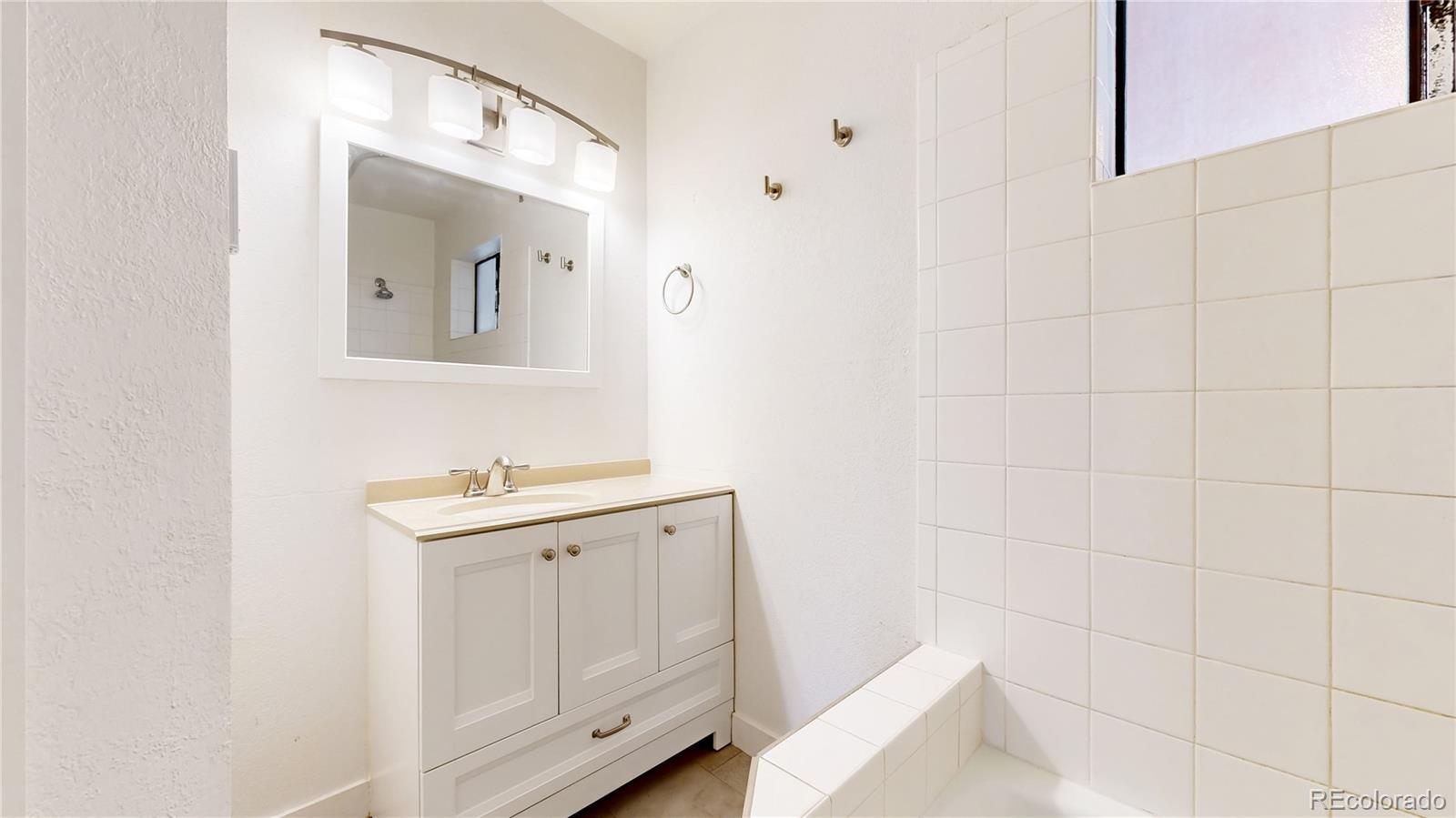 1934 18th Street, Unit 8 Boulder, CO 80302 - Photo 13 of 41 a bathroom with a sink a toilet and mirror