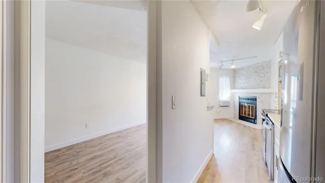 a view of a hallway with wooden floor and staircase