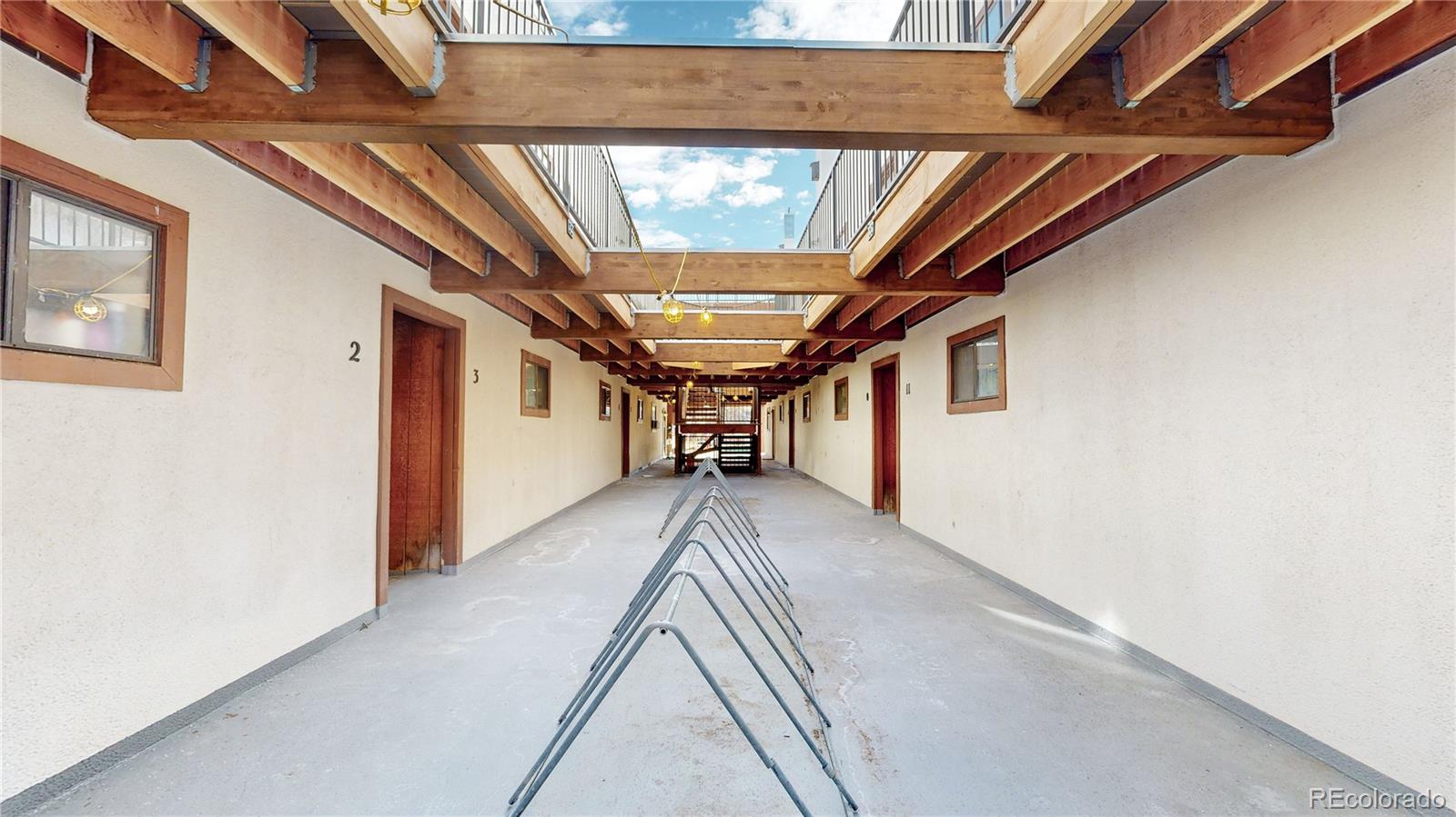 1934 18th Street, Unit 8 Boulder, CO 80302 - Photo 18 of 41 a view of a hallway with wooden floor and staircase