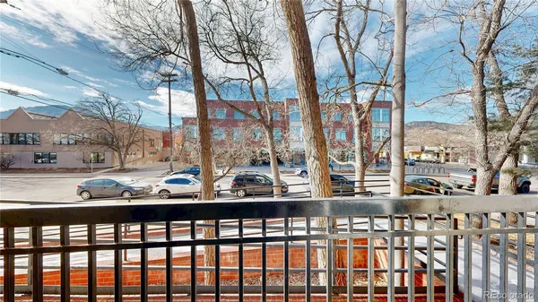 a city view from a balcony with furniture