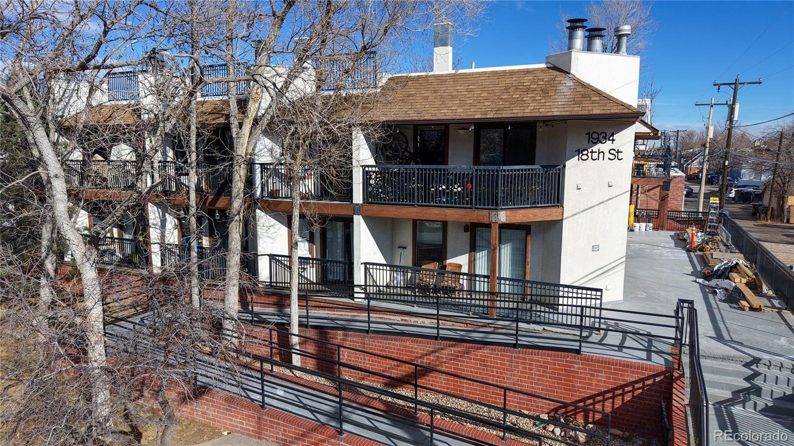 1934 18th Street, Unit 8 Boulder, CO 80302 - Photo 4 of 41 a view of a patio with table and chairs with wooden floor and fence
