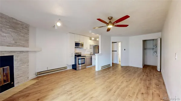 a view of a kitchen with a sink and a refrigerator