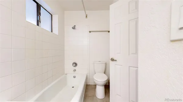 a bathroom with a bathtub and a toilet