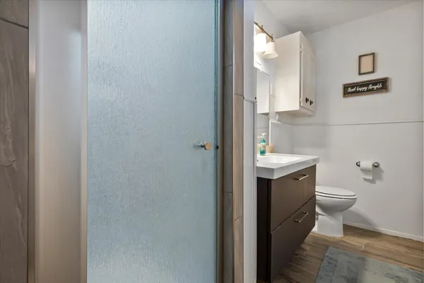 a bathroom with a toilet sink and mirror
