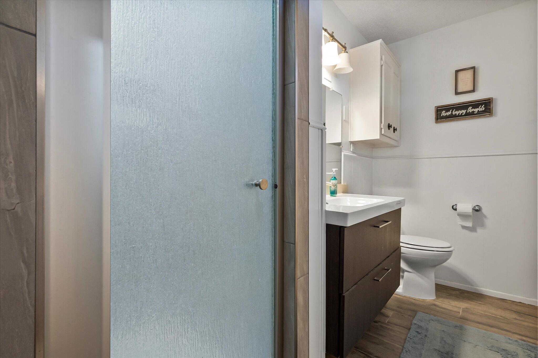 4904 15th Street Lubbock, TX 79416 - Photo 11 of 29 a bathroom with a toilet sink and mirror