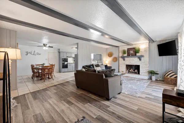a living room with furniture a fireplace and a flat screen tv