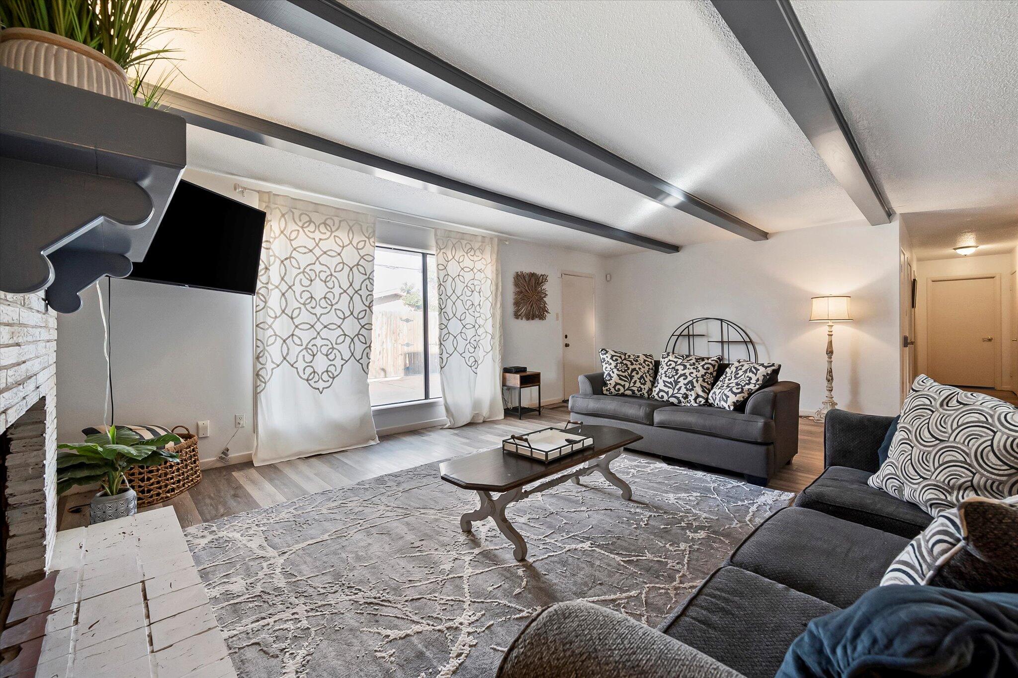 4904 15th Street Lubbock, TX 79416 - Photo 17 of 29 a living room with furniture and a flat screen tv