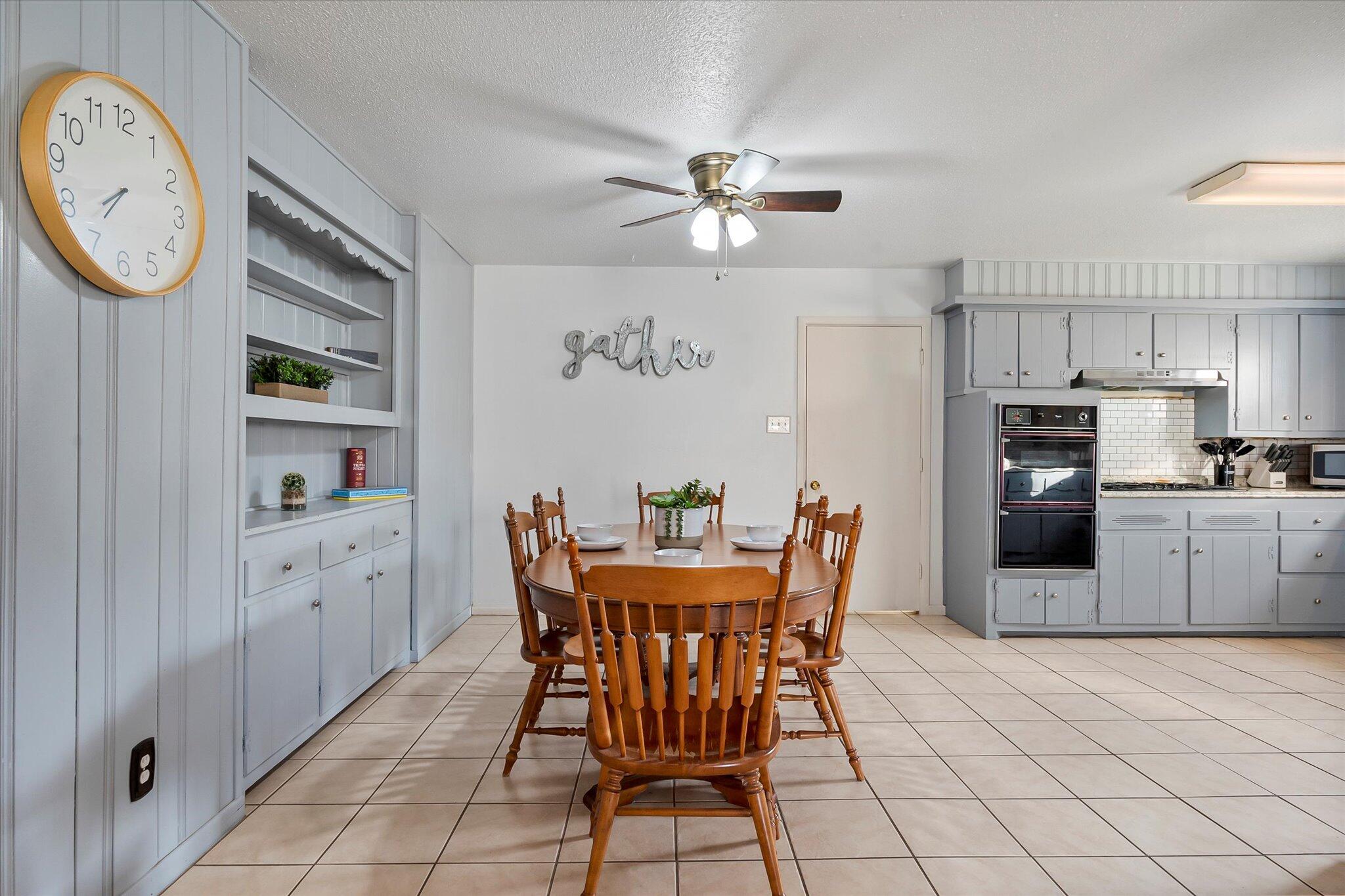 4904 15th Street Lubbock, TX 79416 - Photo 19 of 29 a view of a dining room with furniture and wooden floor