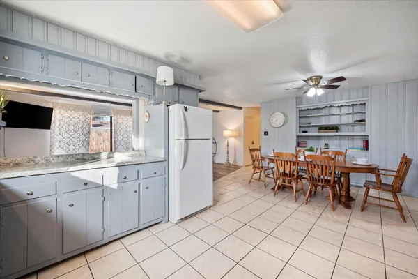 a kitchen with granite countertop white cabinets and white appliances