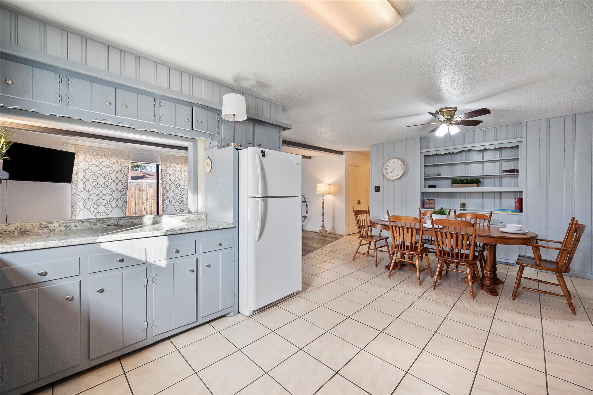 4904 15th Street Lubbock, TX 79416 - Photo 23 of 29 a group of chairs sitting in a kitchen with white cabinets