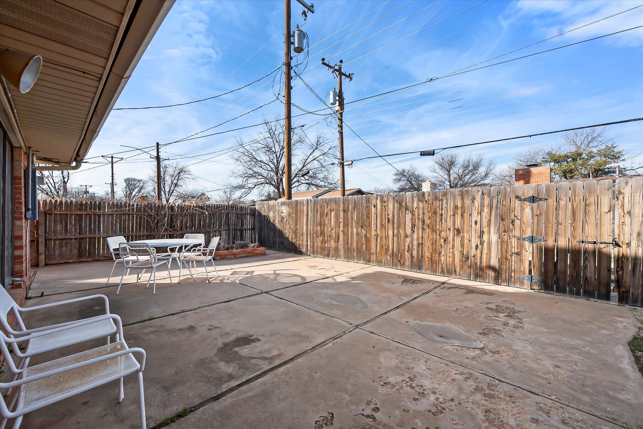 4904 15th Street Lubbock, TX 79416 - Photo 27 of 29 a view of a patio with a table and chairs