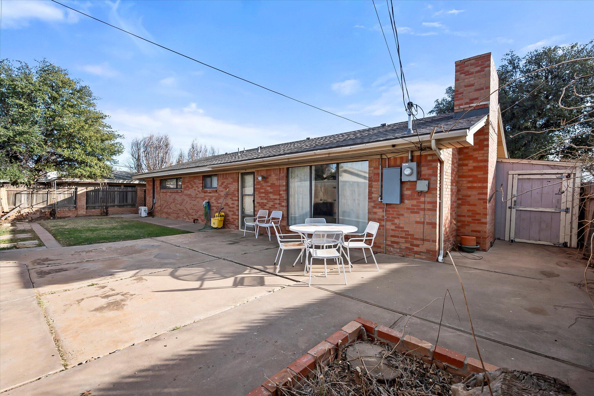 4904 15th Street Lubbock, TX 79416 - Photo 28 of 29 a view of a patio with table and chairs and floor to ceiling window