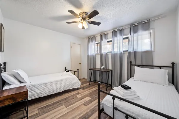 a bedroom with a bed and a chandelier