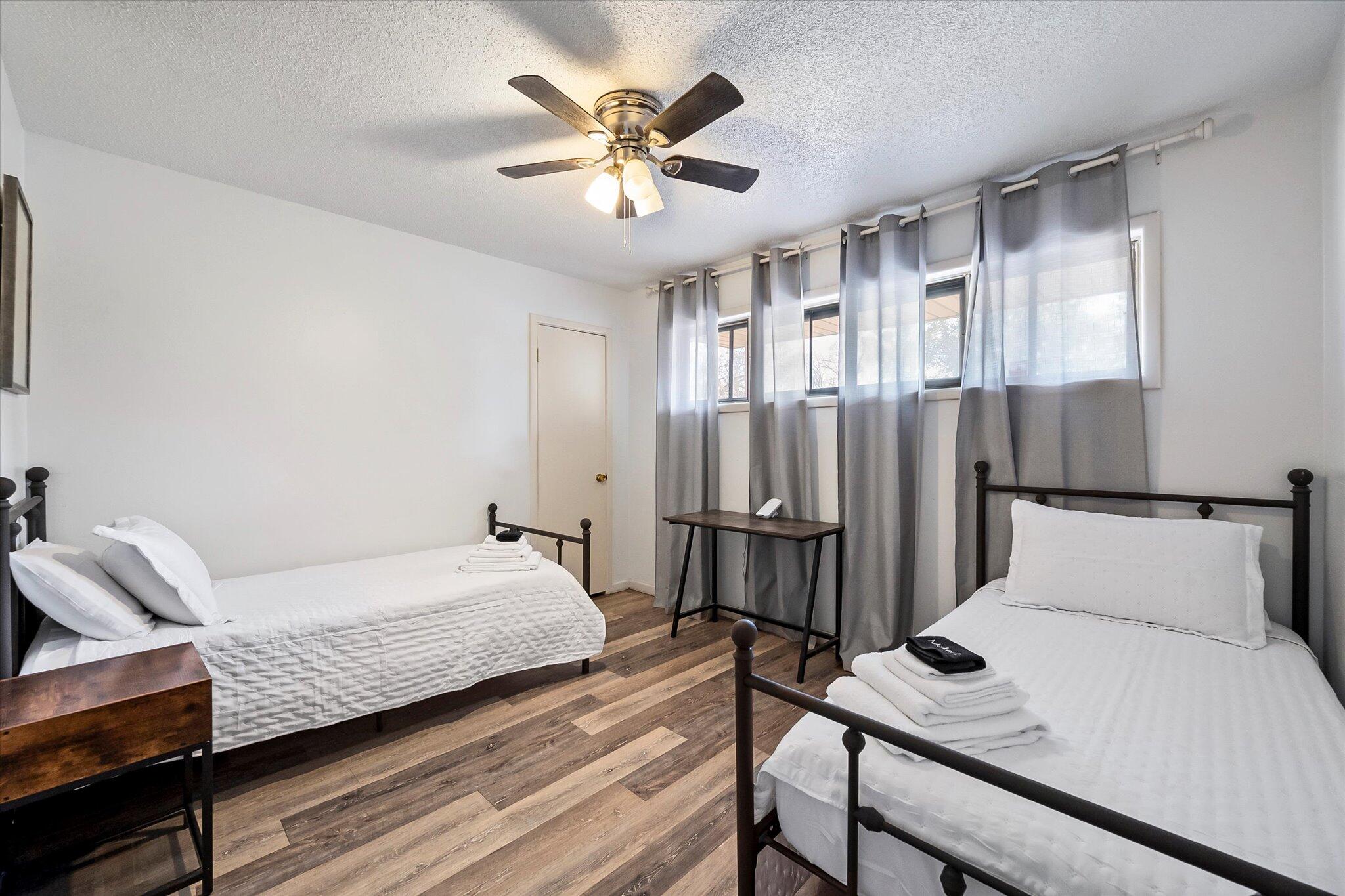4904 15th Street Lubbock, TX 79416 - Photo 6 of 29 a bedroom with a bed and a chandelier