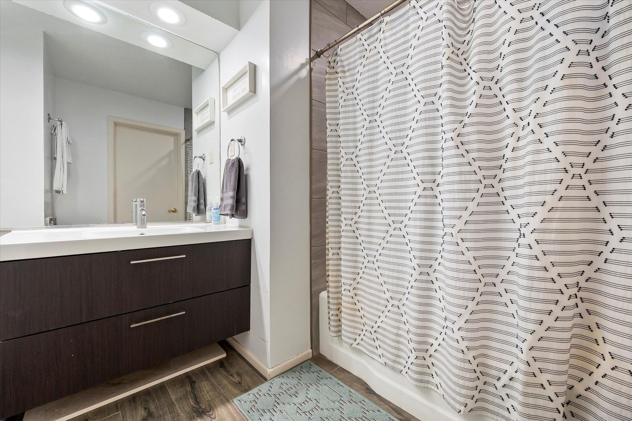 4904 15th Street Lubbock, TX 79416 - Photo 7 of 29 a bathroom with a sink and a mirror