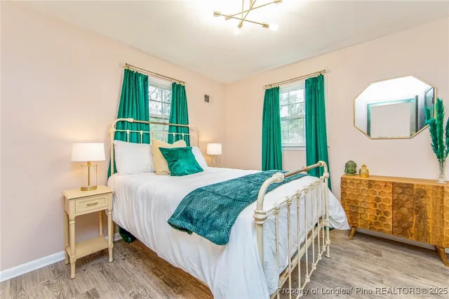 a white bath tub sitting in a bedroom next to a window