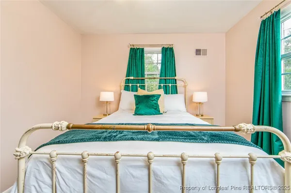 a bedroom with a bed and a chandelier