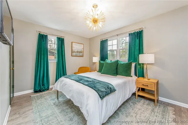 a bedroom with a bed and a chandelier