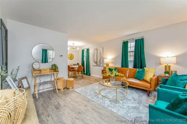 a living room with furniture and a lamp