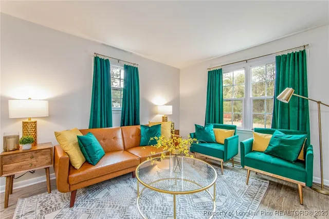 a living room with furniture and a mirror