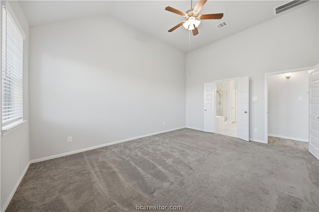 4316 Mocking Run Lane Dickinson, TX 77539 - Photo 12 of 24 an empty room with chandelier fan and windows