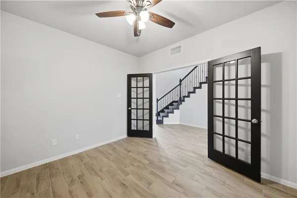 a view of entryway and hall with wooden floor
