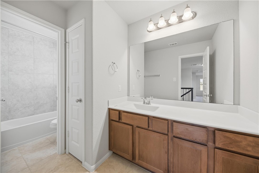 4316 Mocking Run Lane Dickinson, TX 77539 - Photo 17 of 24 a bathroom with a double vanity sink and a mirror