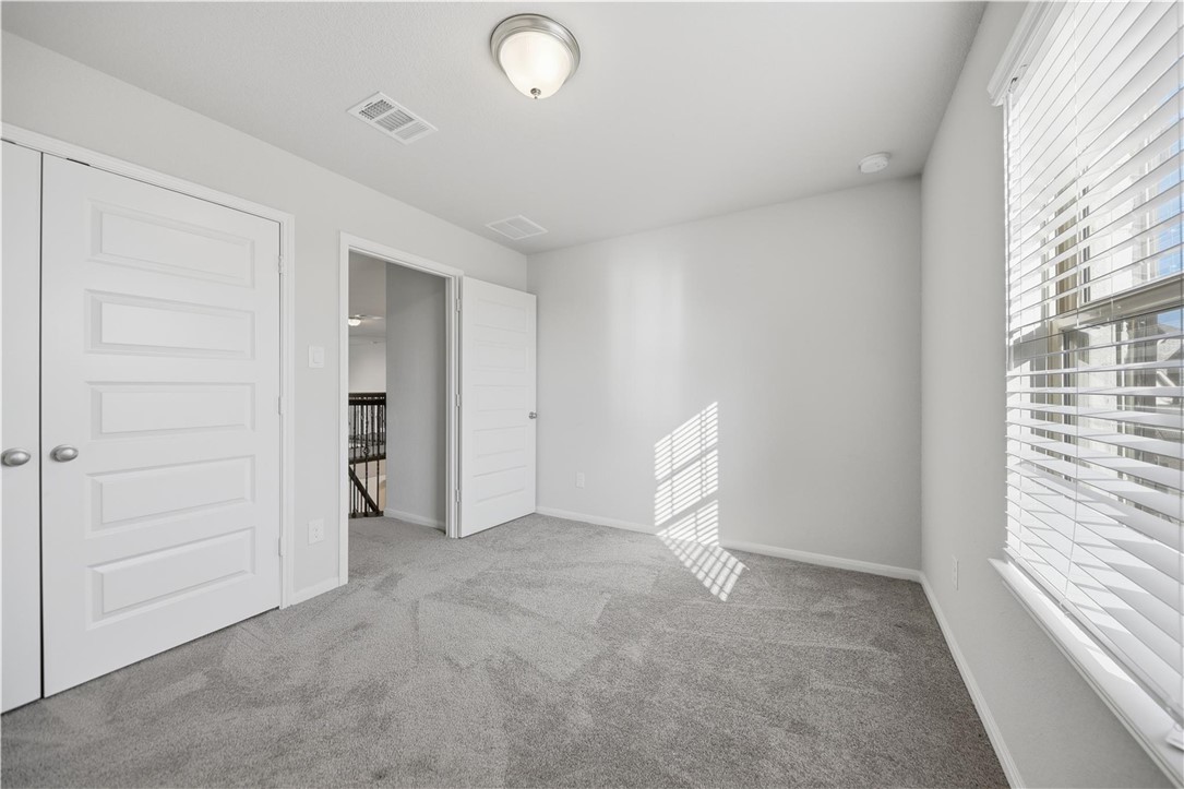 4316 Mocking Run Lane Dickinson, TX 77539 - Photo 18 of 24 an empty room with closet and windows