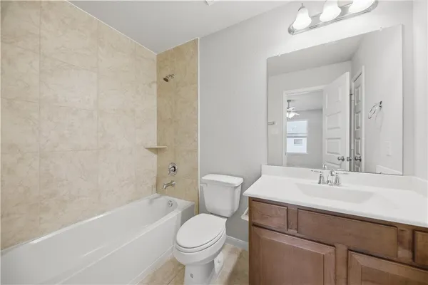 a bathroom with a sink toilet vanity and bathtub