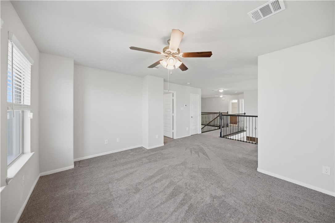 4316 Mocking Run Lane Dickinson, TX 77539 - Photo 22 of 24 a view of a livingroom with a ceiling fan and a window