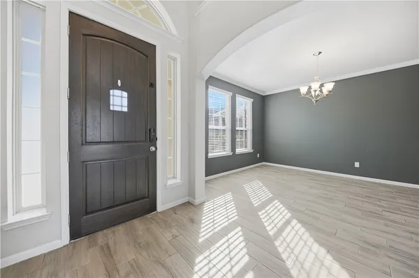 a view of a livingroom with wooden floor and cabinet