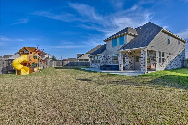 a view of a house with a backyard porch and furniture