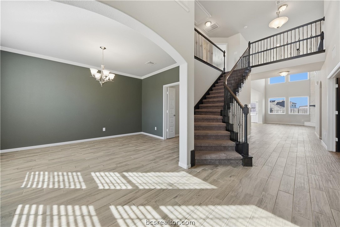 4316 Mocking Run Lane Dickinson, TX 77539 - Photo 6 of 24 a view of a hallway with wooden floor and staircase