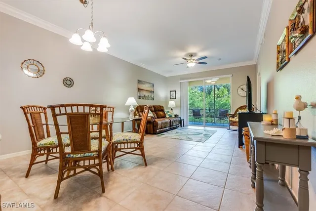 a living room with furniture a chandelier and a large window