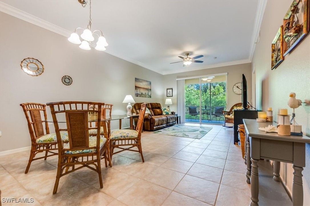 8251 Pathfinder Loop, Unit 615 Fort Myers, FL 33919 - Photo 12 of 44 a living room with furniture a chandelier and a large window