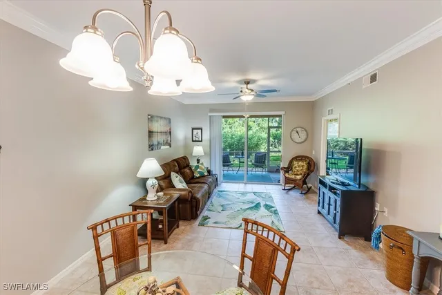 a living room with furniture fireplace and chandelier
