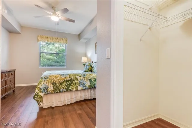 a bedroom with a bed chandelier and a window