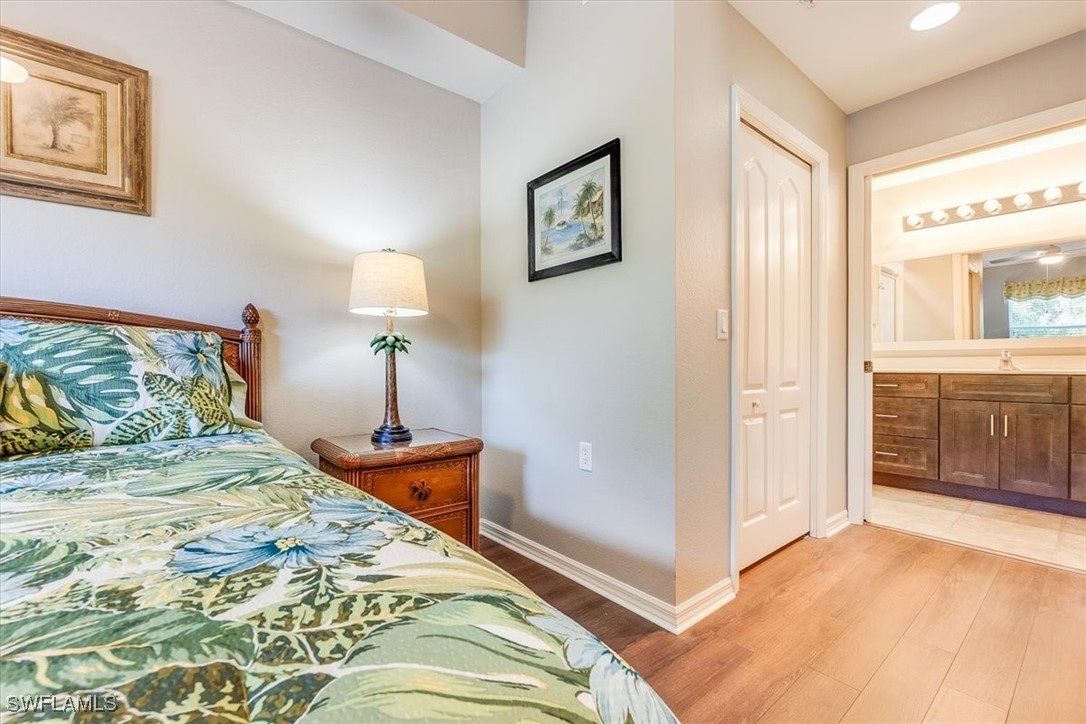 8251 Pathfinder Loop, Unit 615 Fort Myers, FL 33919 - Photo 21 of 44 a bedroom with a bed and a lamp