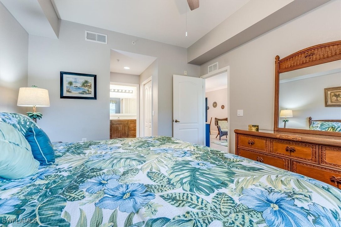 8251 Pathfinder Loop, Unit 615 Fort Myers, FL 33919 - Photo 24 of 44 a bedroom with a bed and a dresser
