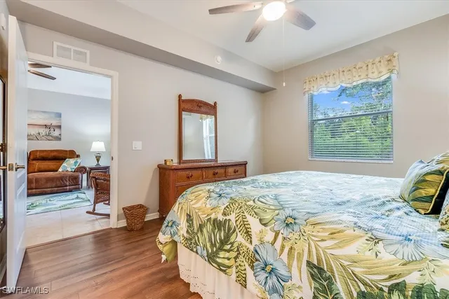 a bedroom with a bed and a large mirror