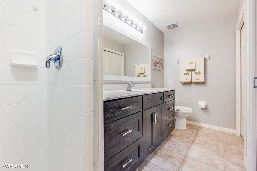8251 Pathfinder Loop, Unit 615 Fort Myers, FL 33919 - Photo 27 of 44 a bathroom with a granite countertop sink a toilet and a mirror