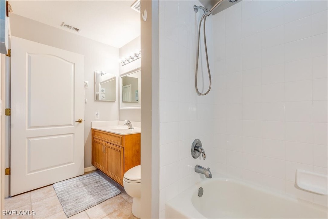 8251 Pathfinder Loop, Unit 615 Fort Myers, FL 33919 - Photo 30 of 44 a bathroom with a tub shower and sink