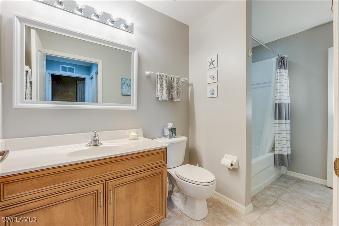 8251 Pathfinder Loop, Unit 615 Fort Myers, FL 33919 - Photo 31 of 44 a bathroom with a toilet sink and mirror