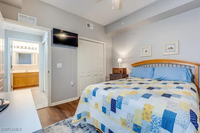 a bedroom with a bed and wooden floor