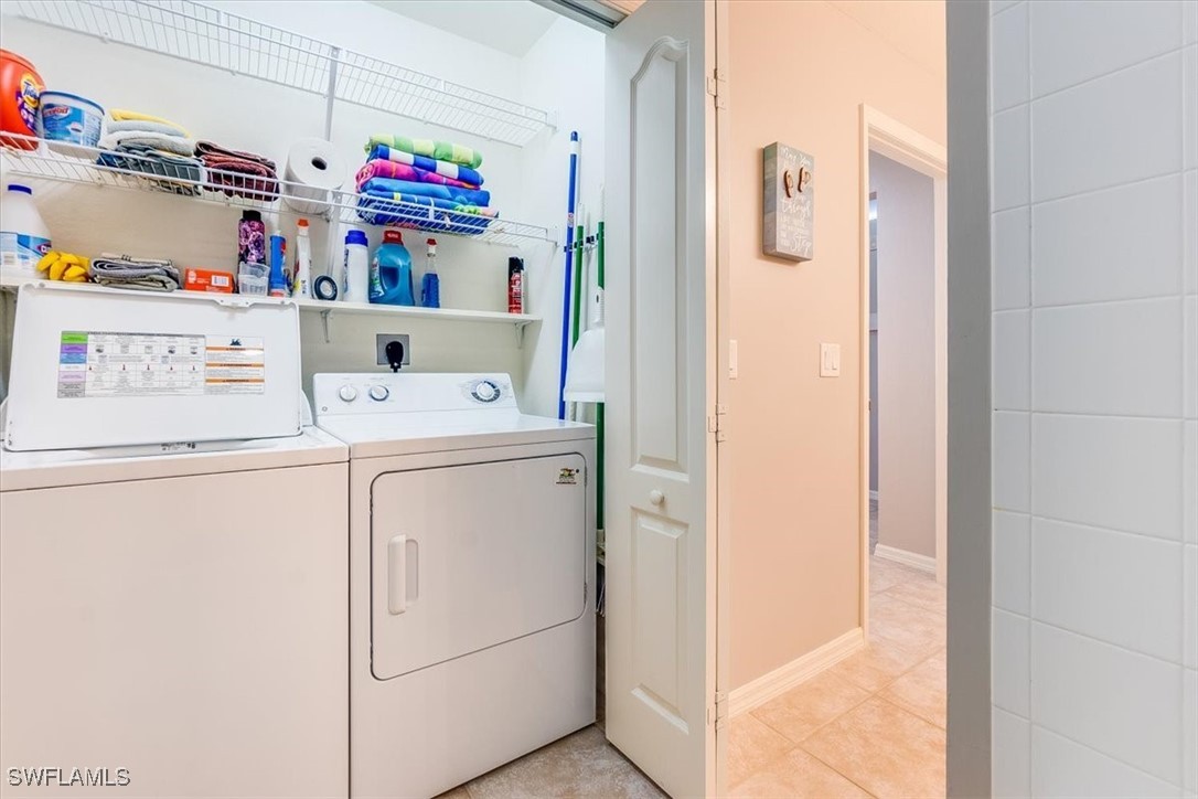 8251 Pathfinder Loop, Unit 615 Fort Myers, FL 33919 - Photo 39 of 44 a utility room with dryer and washer