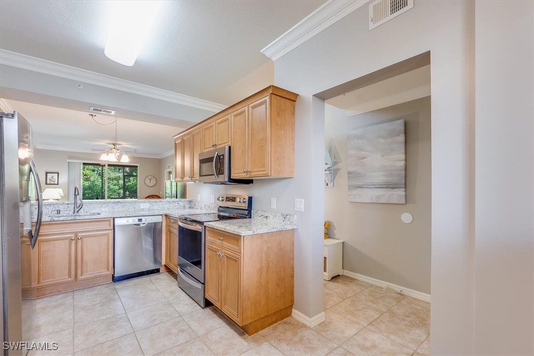 8251 Pathfinder Loop, Unit 615 Fort Myers, FL 33919 - Photo 4 of 44 a kitchen with a stove top oven and sink