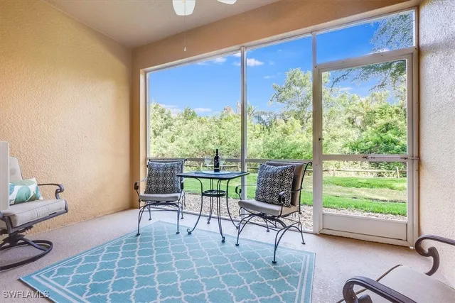 a living room with furniture and a floor to ceiling window