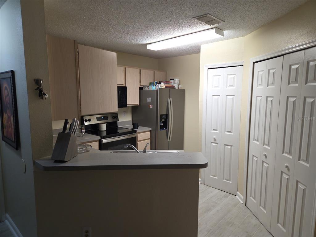 3705 Southwest 27th Street, Unit 422 Gainesville, FL 32608 - Photo 11 of 25 a kitchen with stainless steel appliances a refrigerator and a sink