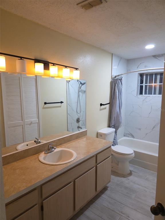 3705 Southwest 27th Street, Unit 422 Gainesville, FL 32608 - Photo 18 of 25 a bathroom with a double vanity sink toilet and shower