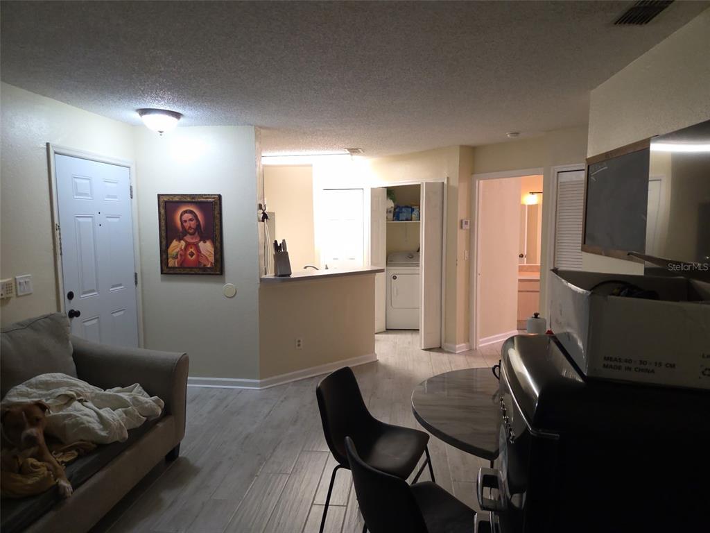 3705 Southwest 27th Street, Unit 422 Gainesville, FL 32608 - Photo 19 of 25 a living room with furniture and a flat screen tv